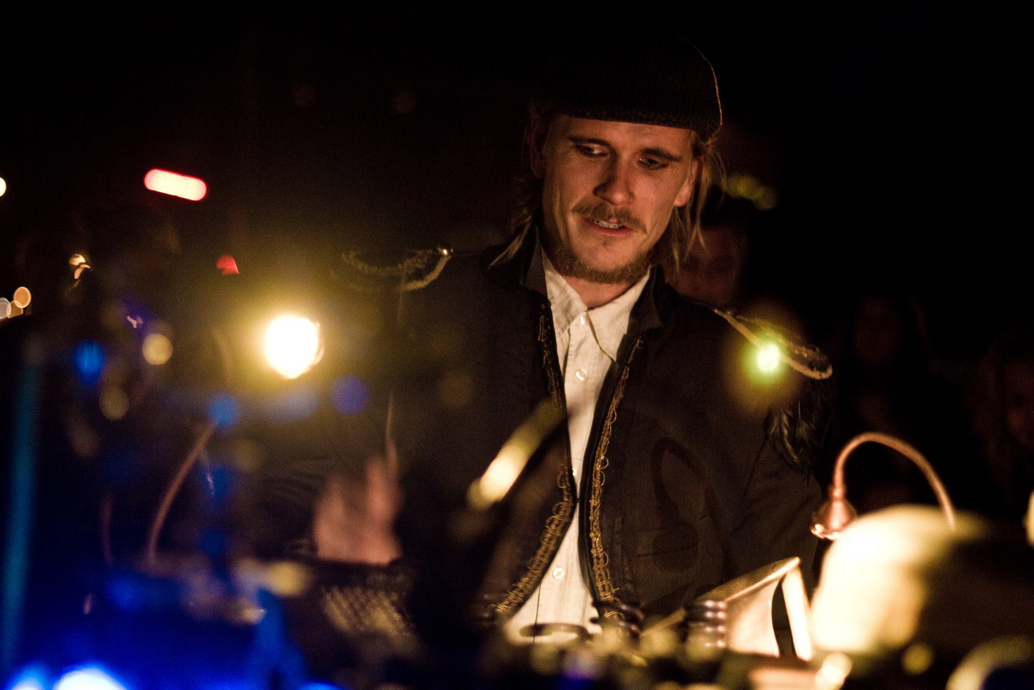 Hjalte playing live, lit by stage lights
